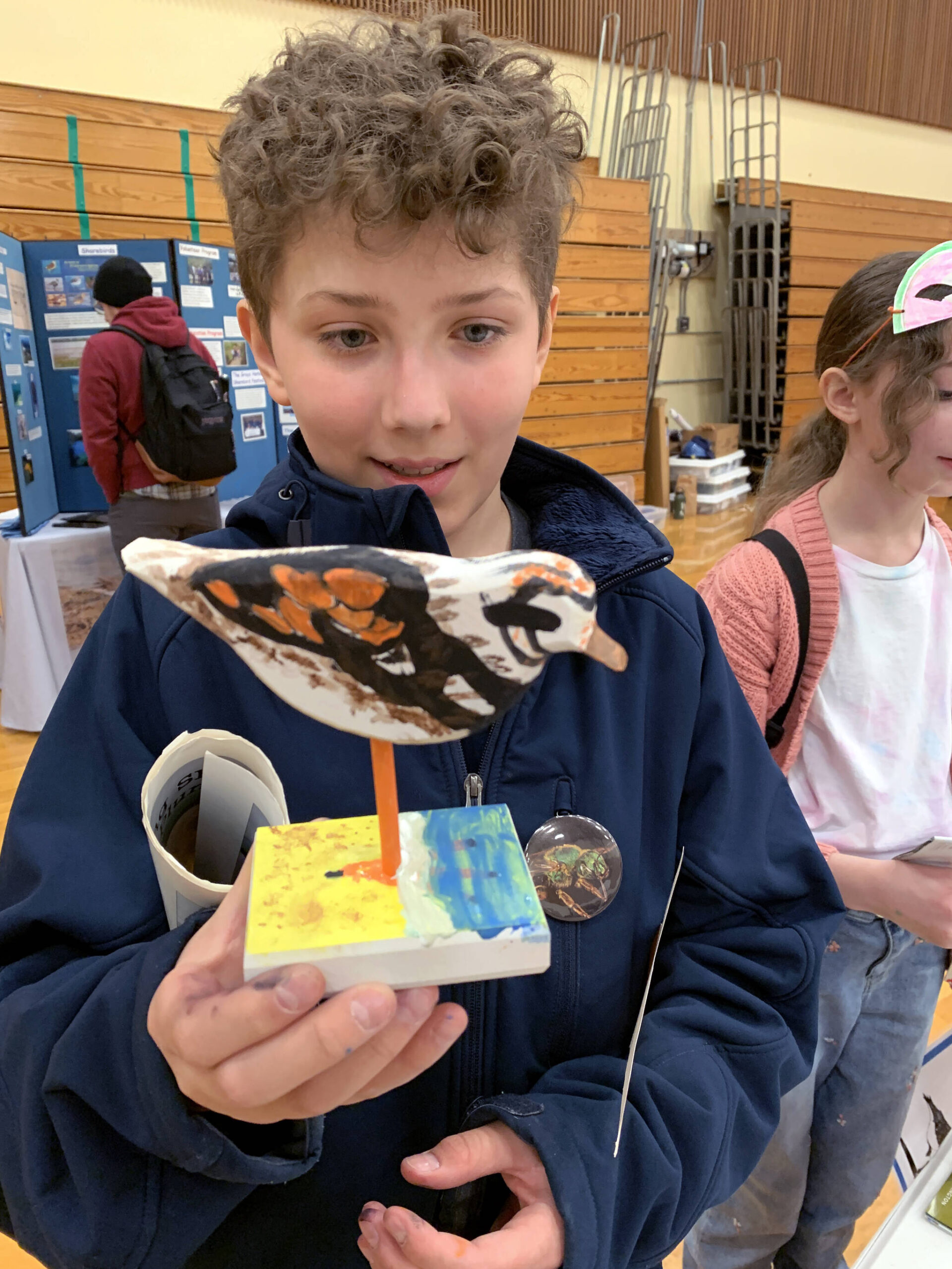 Julia Pinnix / U.S. Fish and Wildlife Service
14-year-old Dryden Quinton holds a model of a ruddy turnstone at the 2024 Grays Harbor Shorebird Festival.