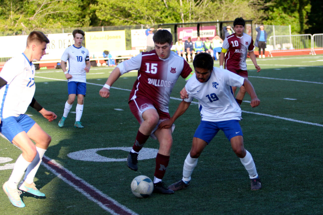 RYAN SPARKS | THE DAILY WORLD Montesano junior forward Felix Romero (15) holds possession against La Center midfielder Chemo Esquivel-Soto during a 3-2 win over La Center in the 1A District 4 Tournament on Tuesday in Montesano.