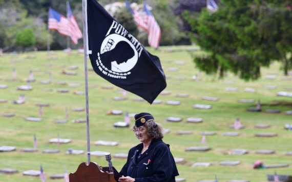 Gwen Tarrance reads the remembrance for prisoners of war during a Memorial Day ceremony at Fern Hill Cemetery on Monday. (Michael S. Lockett / The Daily World)