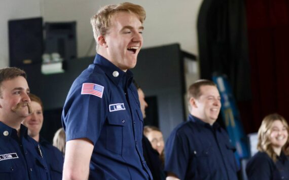 Michael S. Lockett / The Daily World
Members of the county fire academy, with Liam Burke of District 7 in the foreground, celebrate during the graduation ceremony.