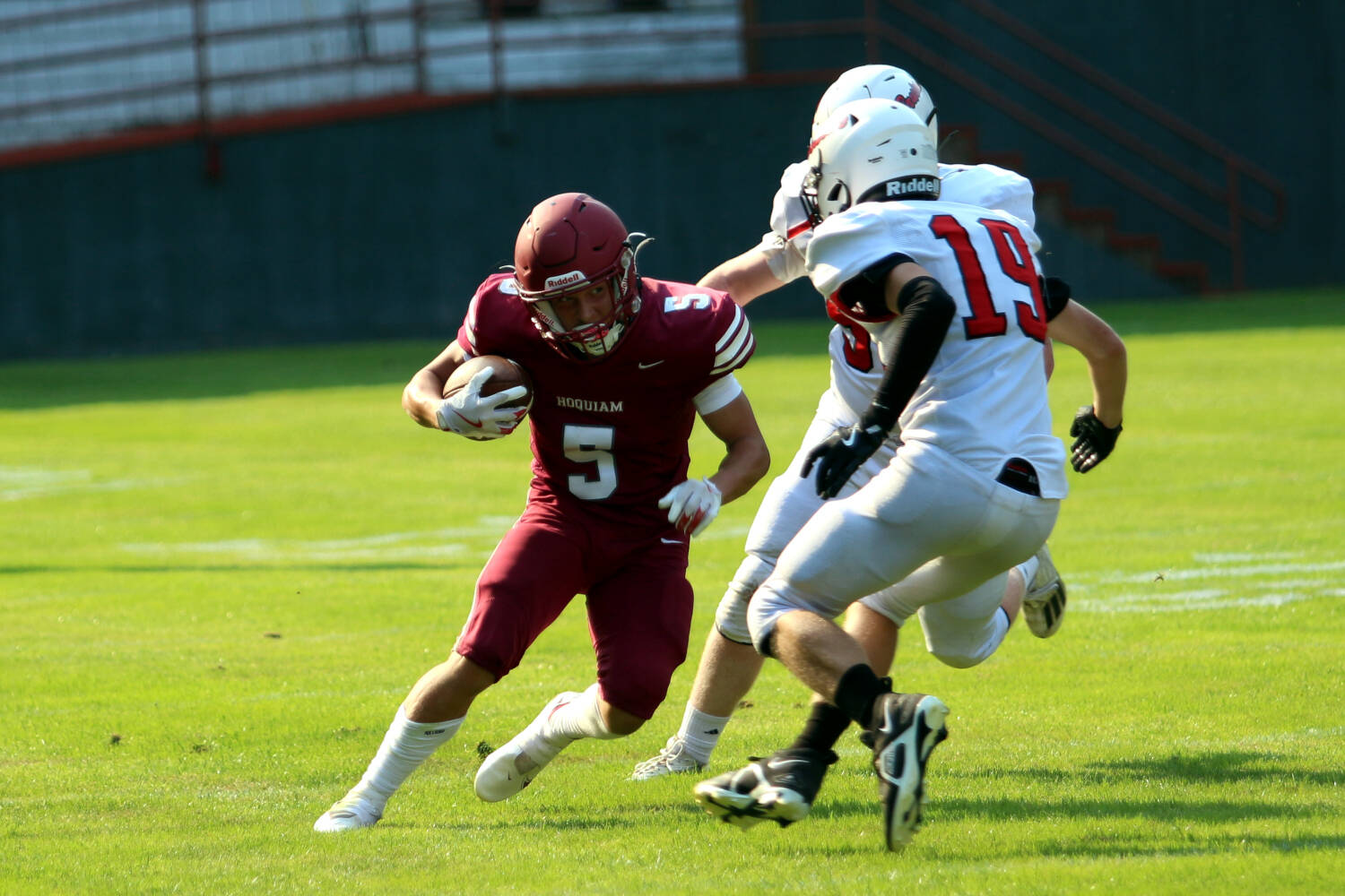 RYAN SPARKS | THE DAILY WORLD Hoquiam running back Kingston Case (5) wiggles away from Columbia (White Salmon) defenders during a 16-13 loss on Friday at Olympic Stadium in Hoquiam.