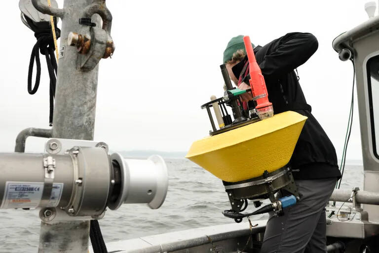 Alex de Klerk prepares to heave one of the teams research buoys overboard.