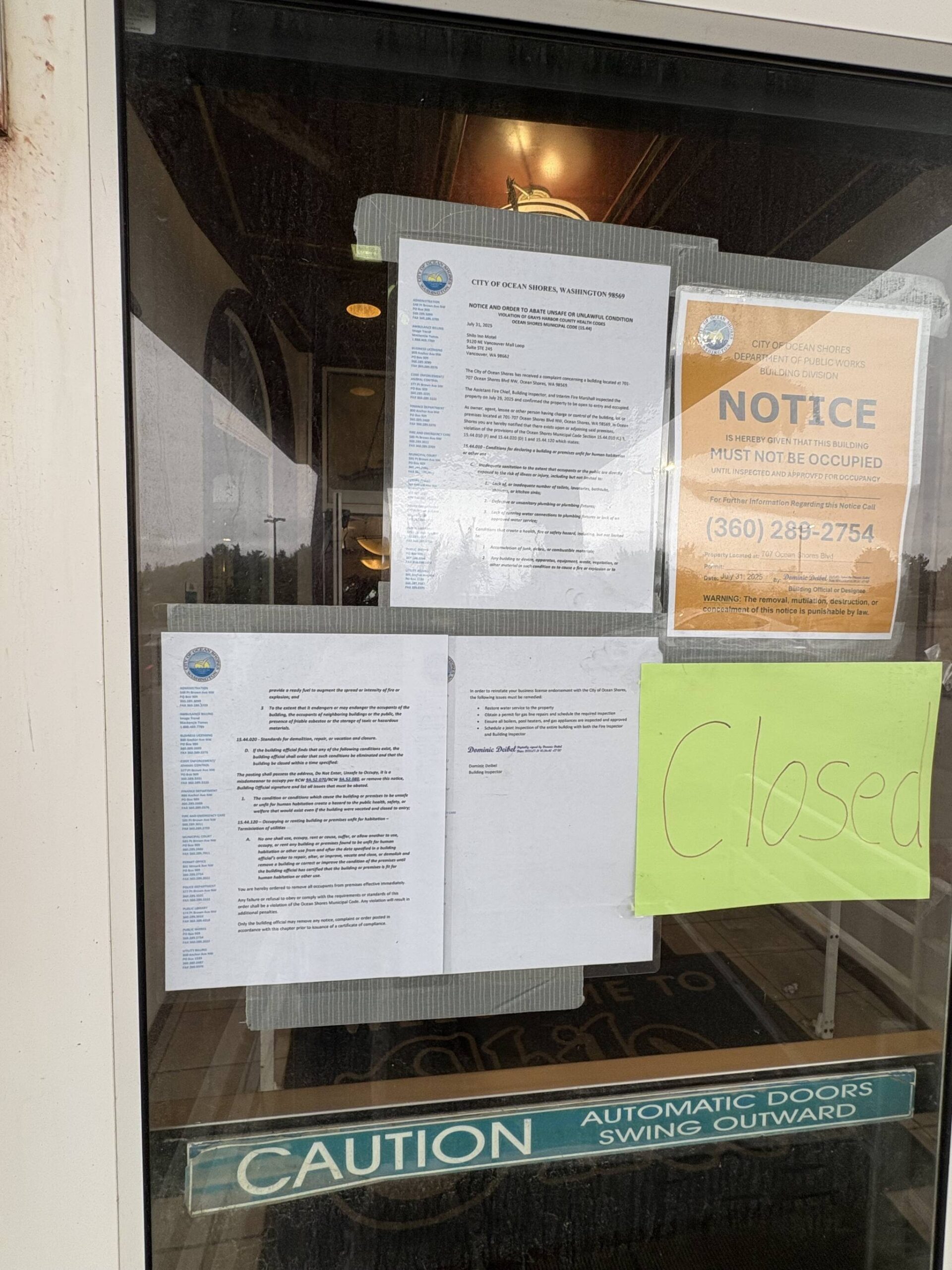 Posting on the door of the Shilo Inns Ocean Shores details several code violations.