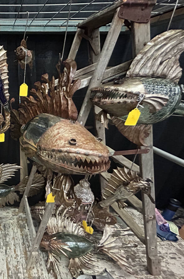 Intricate glass and metal art pieces from a vendor at the Ocean Shores Art Festival.