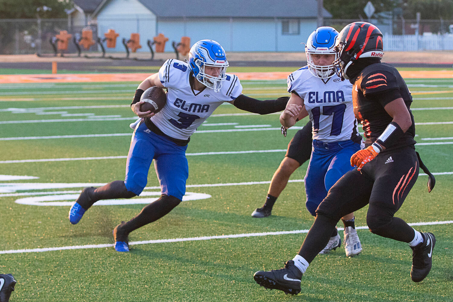 DYLAN WILHELM | THE CHRONICLE Elma quarterback Isaac McGaffey (3) follows the block of Kolby Rademacher (17) during a 41-28 victory over Centralia on Friday in at Tigers Stadium in Centralia.