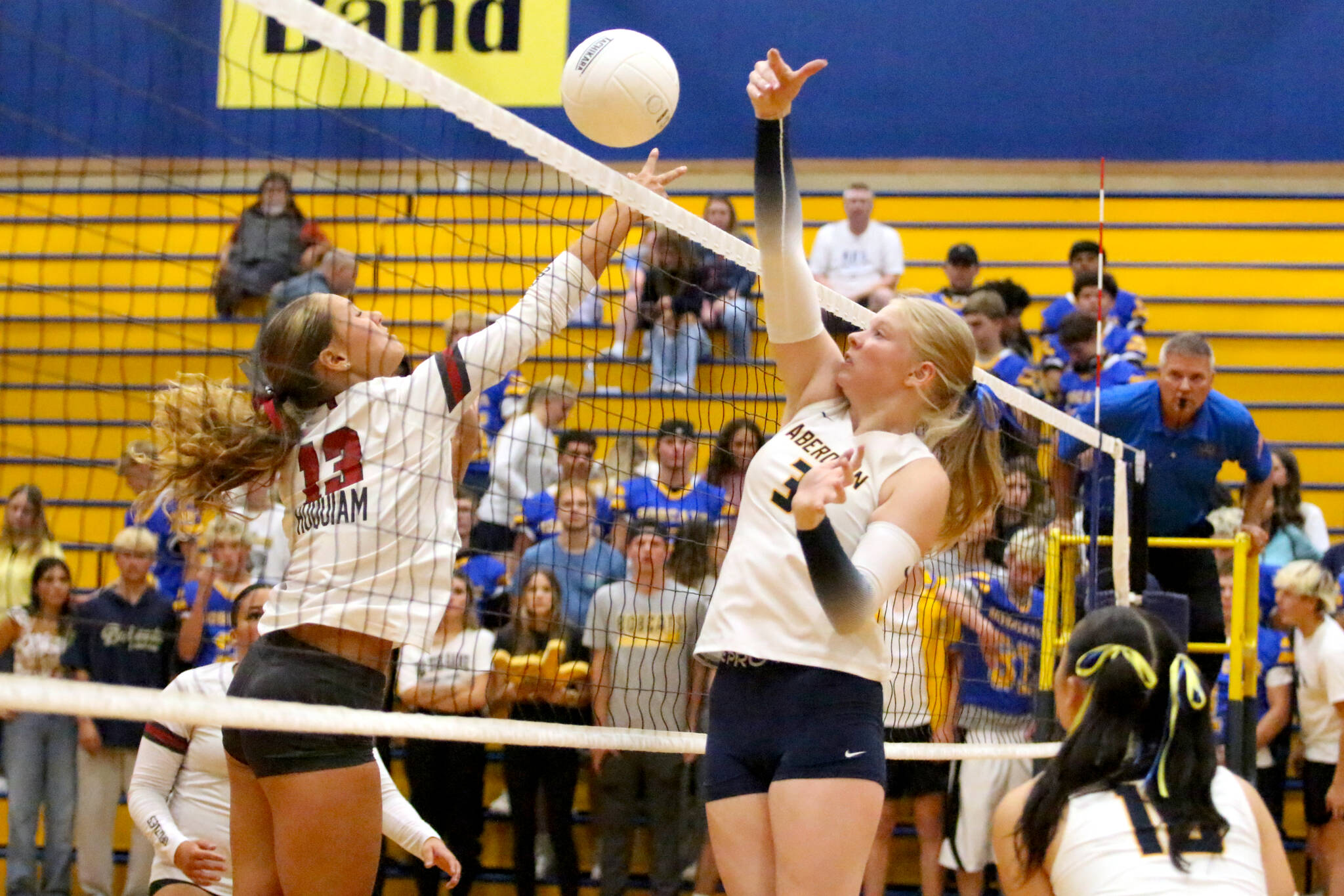 RYAN SPARKS | THE DAILY WORLD Hoquiams Piper Stankavich (left) and Aberdeens Dallyn Williams meet at the net during the Bobcats 3-1 win on Thursday at Sam Benn Gym in Aberdeen.