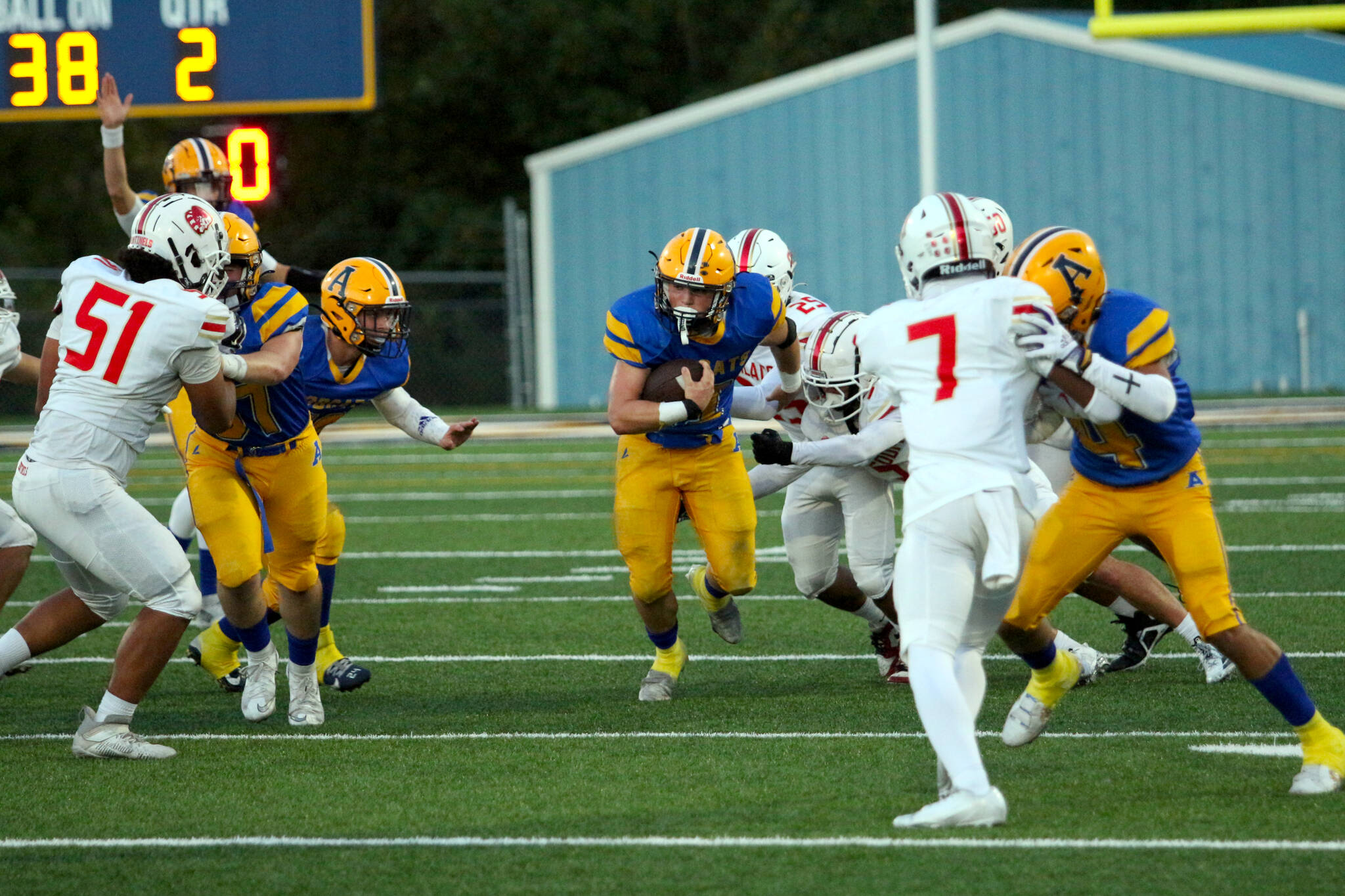 RYAN SPARKS | THE DAILY WORLD Aberdeen running back Riley Wixson (middle) runs through the Steliacoom defense during a 19-12 loss on Friday at Stewart Field in Aberdeen.