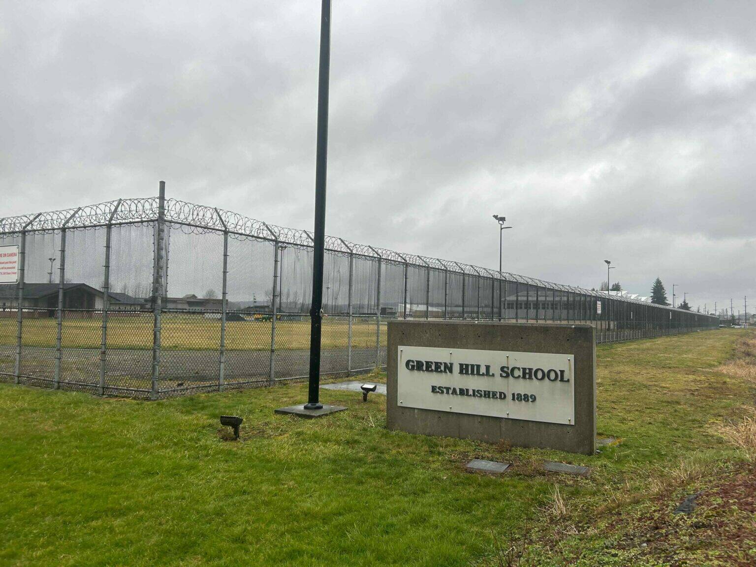 Jake Goldstein-Street / Washington State Standard
A sign and fence at the Green Hill School for juvenile offenders, in Chehalis, Washington.