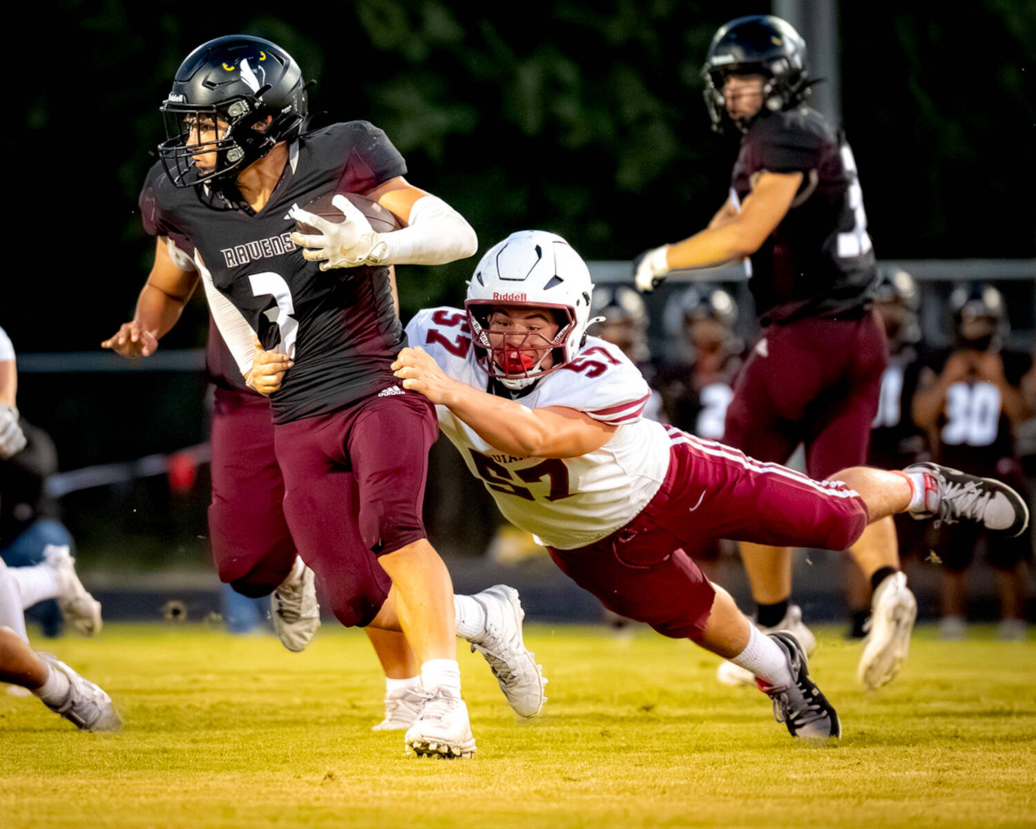 PHOTO BY MATT RUMBLES Raymond-South Bends Keeton Nichols (3) tries to escape the tackle of Hoquiams Jerry Jeremiah during the Grizzlies 31-7 victory on Friday at Raymond High School.