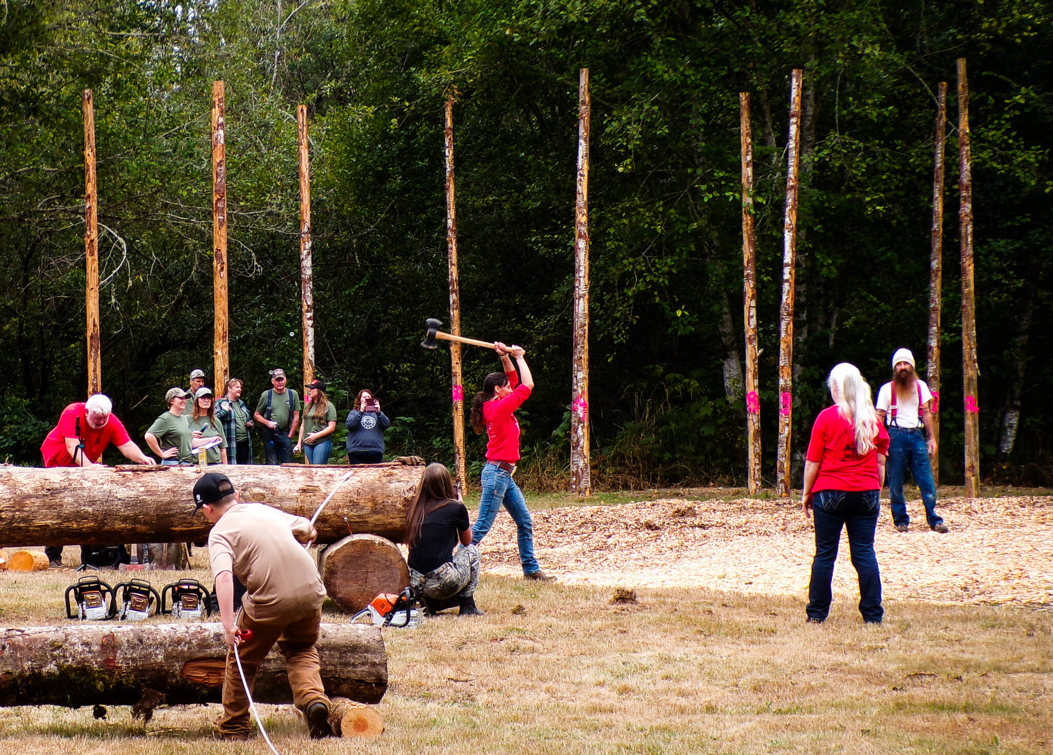 A woman participates in the axe throw.