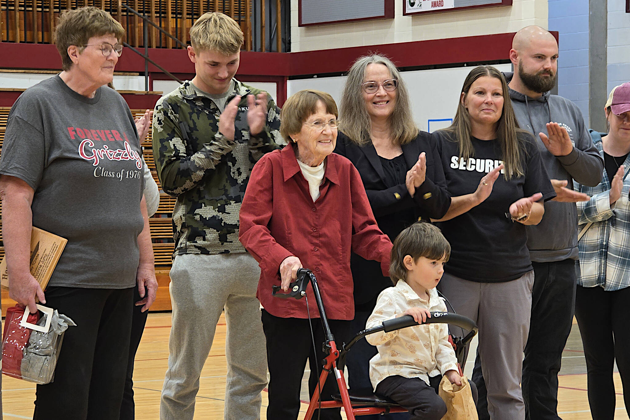 RYAN SPARKS | THE DAILY WORLD Longtime Hoquiam community member Yvonne Jump (third from left) is surrounded by generations of her family during a ceremony ahead of the Aberdeen-Hoquiam volleyball game on Thursday at Hoquiam Square Garden. Jump was honored as a My Town Coalition Hometown Hero for her decades of dedication to the youth of Hoquiam.