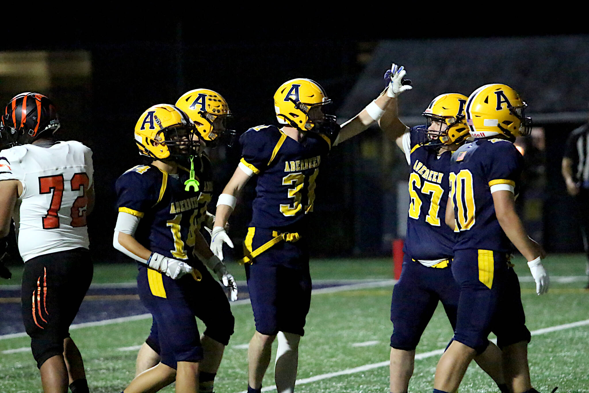 RYAN SPARKS | THE DAILY WORLD Aberdeen running back Gabe Matthews (31) is congratulated by teammate Carter Kolodzie (57) during a 50-20 win over Centralia on Friday at Stewart Field in Aberdeen.