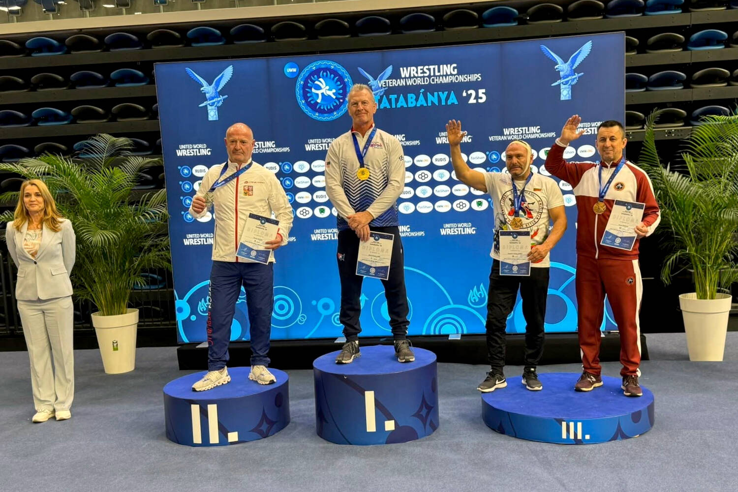 SUBMITTED PHOTO Former Elma wrestler Kevin Pine (1) stands atop the podium after winning a gold medal at the Veteran World Wrestling Championships on Friday in Hungary.