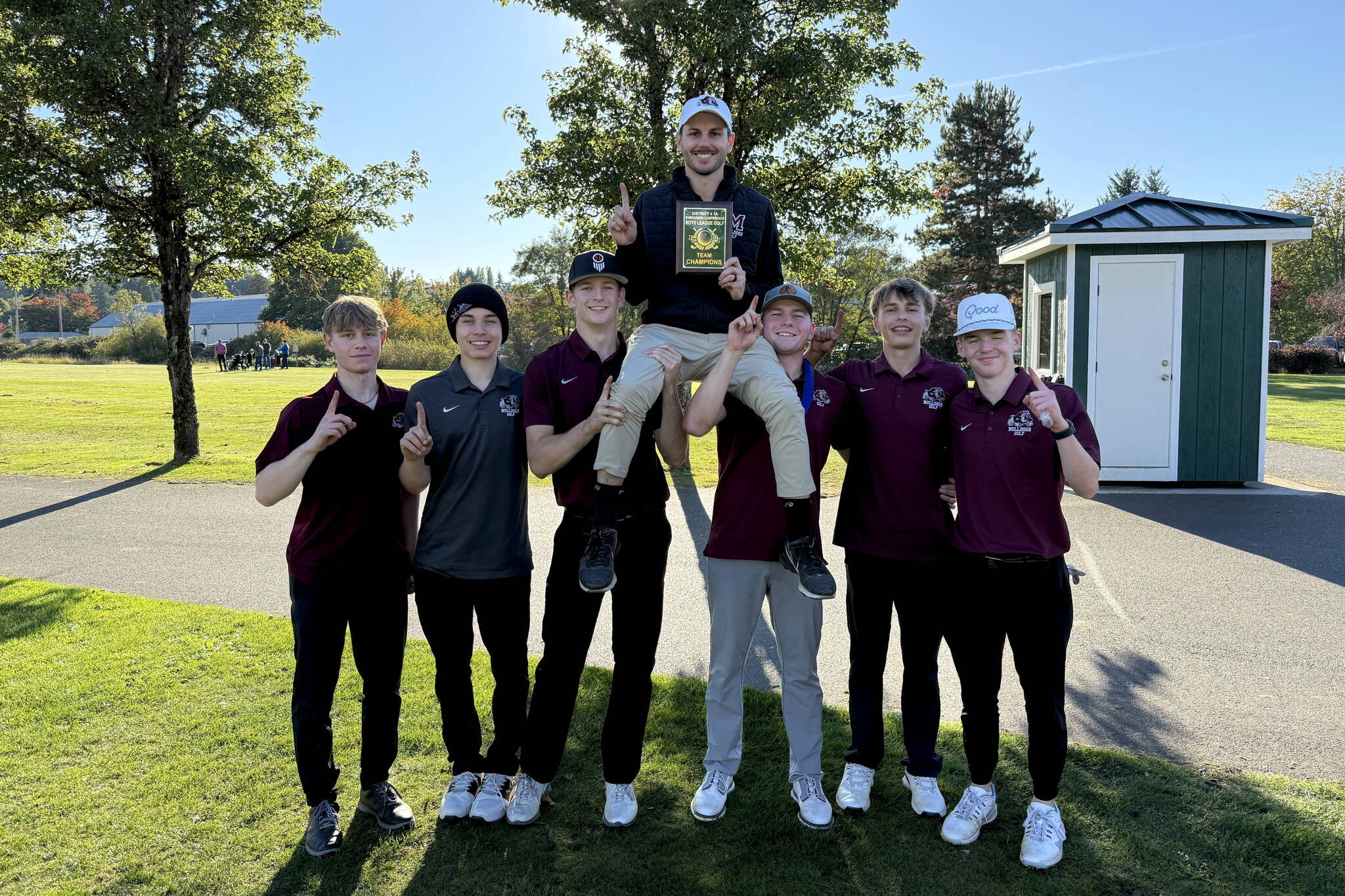 SUBMITTED PHOTO The Montesano Bulldogs pose for a photo with head coach Tyler Grajek (top) after winning the 1A Evergreen League title on Wednesday at the Tumwater Valley Golf Course.