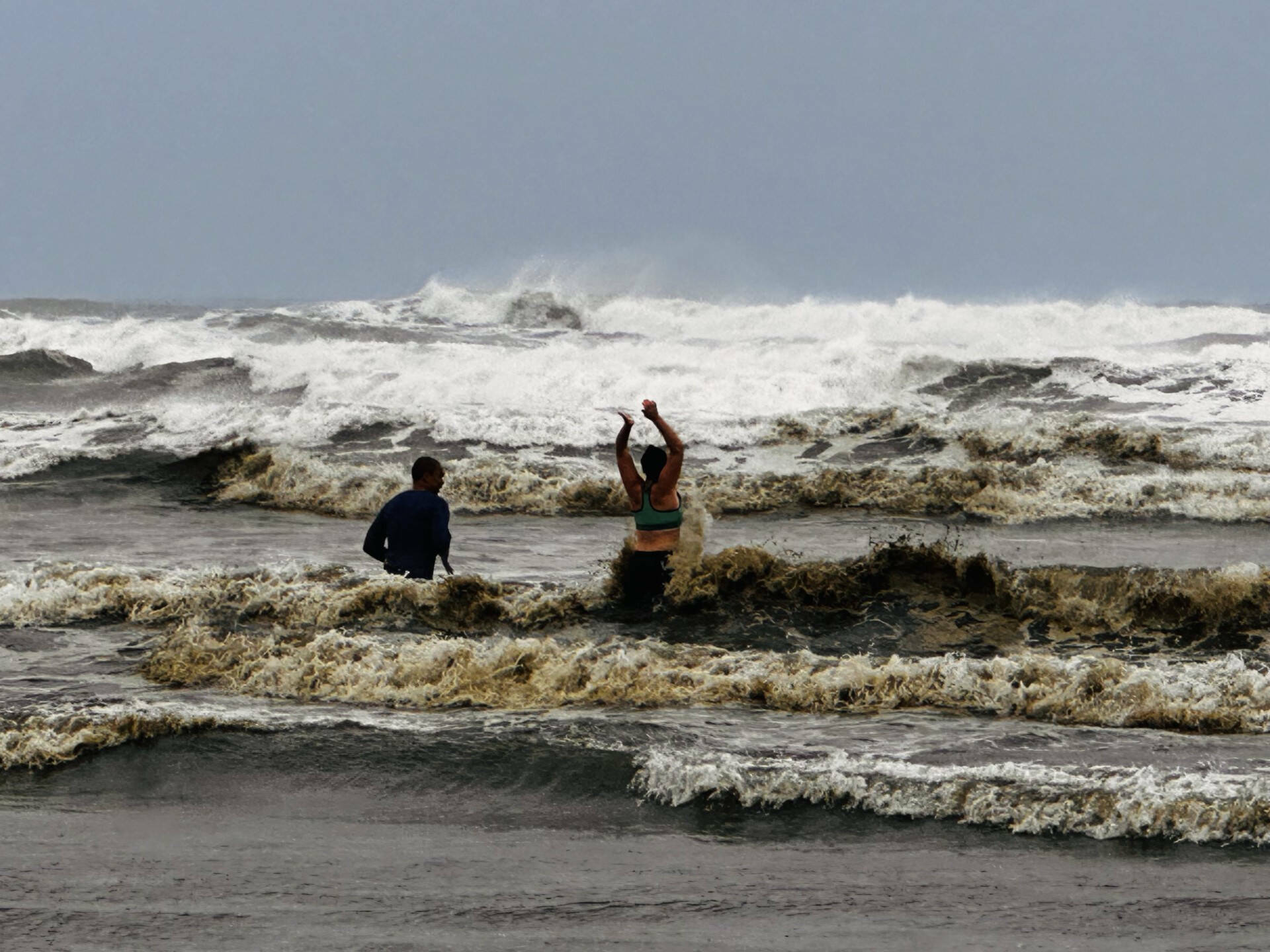 The Daily World file photo
A couple from Tacoma take a cold plunge in Ocean Shores last winter. Sneaker waves are possible over the weekend.