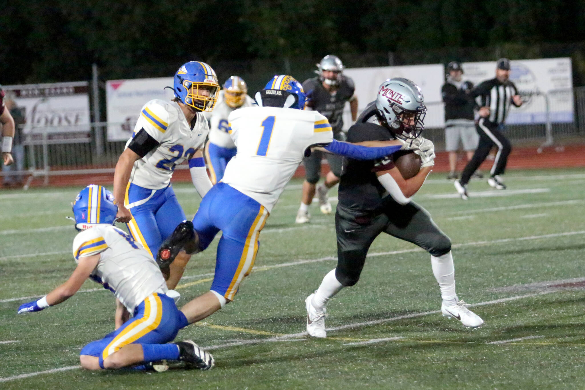 RYAN SPARKS | THE DAILY WORLD Montesanos Toren Crites (12) runs through the tackle of Rochesters Owen Simpkins during the Bulldogs 22-14 victor on Friday at Montesano High School.