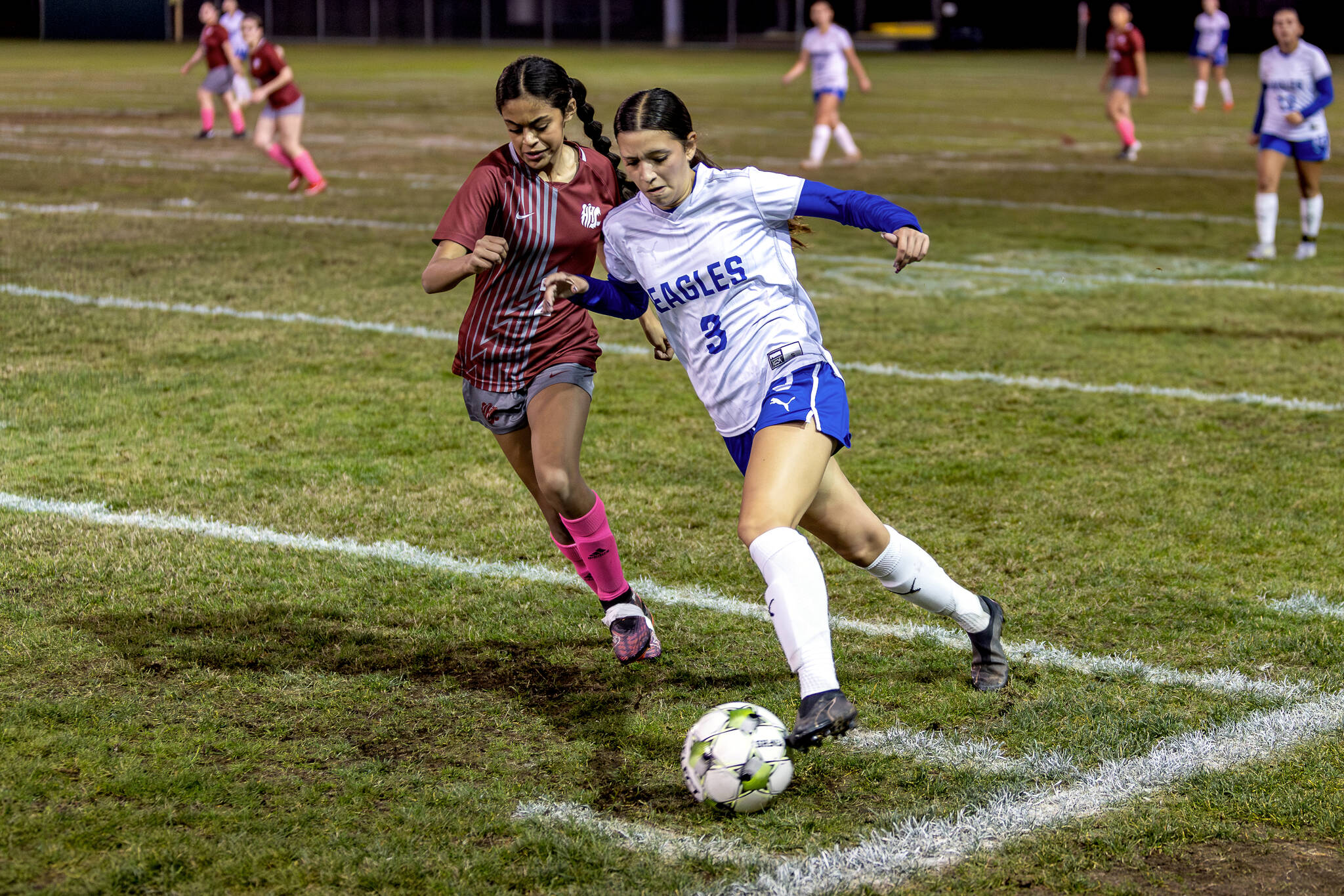 PHOTO BY MIKE ROBERTS Elmas Zippy Valentine (3) is defended by Hoquiams Yazmine Balagot during the Eagles 3-0 win on Thursday at Olympic Stadium in Hoquiam.