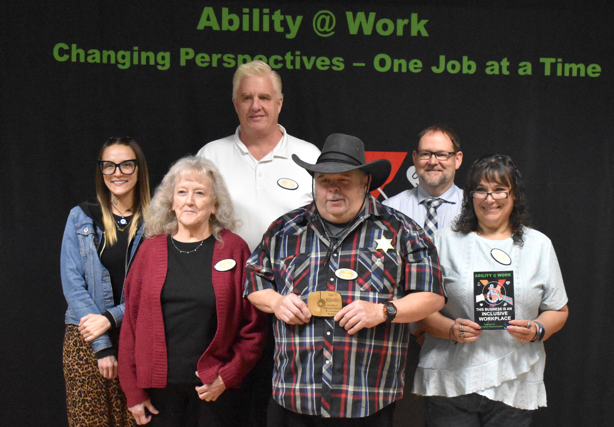 Steve poses for a photo with his Lake Quinault Resort and Casino coworkers and job coach.