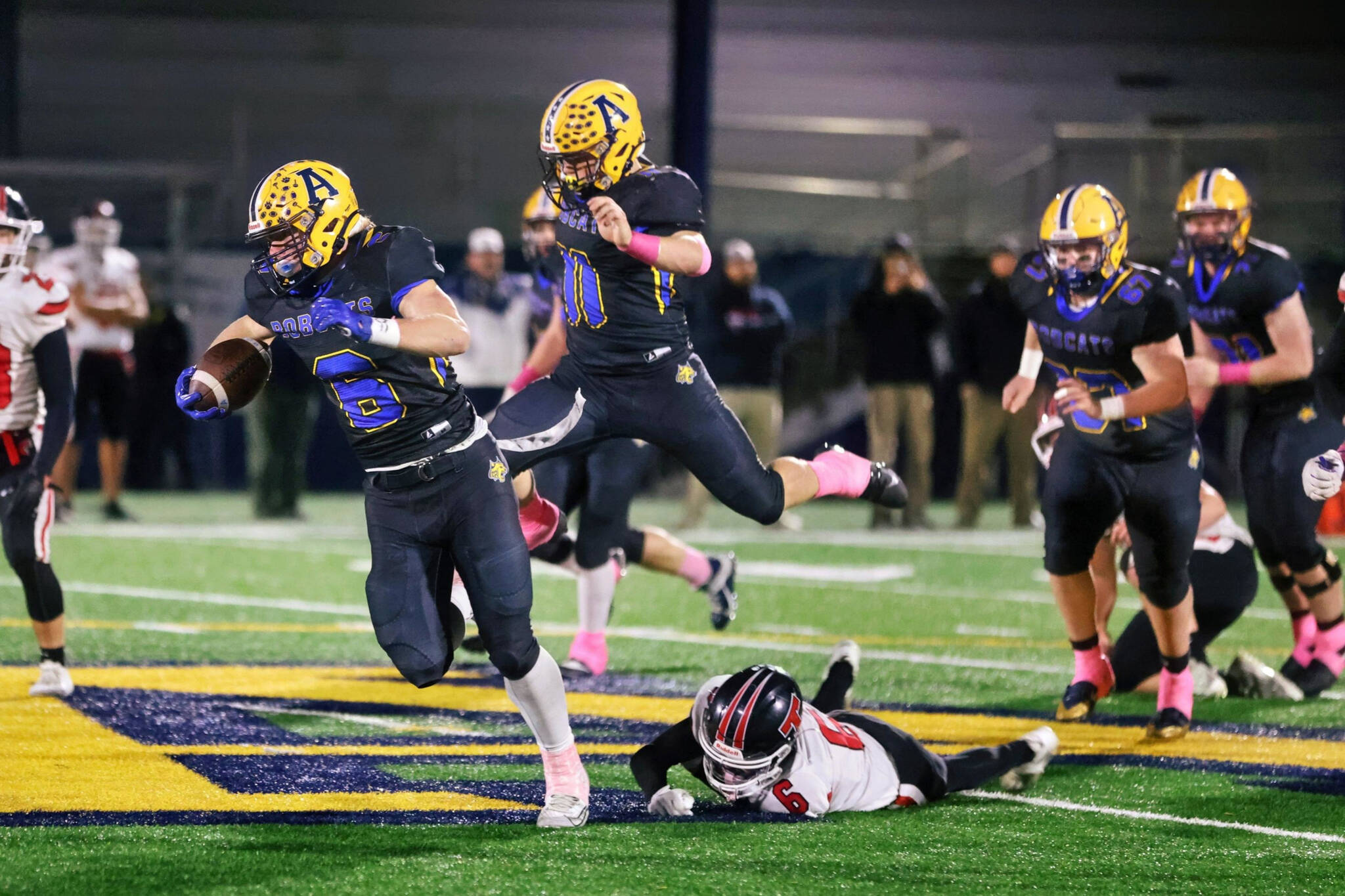 ERICA MCCRORY | MCCRORY PHOTOGRAPHY Aberdeen’s Micah Schroder (left) breaks through the Tenino defense trailed by teammate Riley Wixson (11) during a 33-20 victory on Thursday at Stewart Field in Aberdeen.