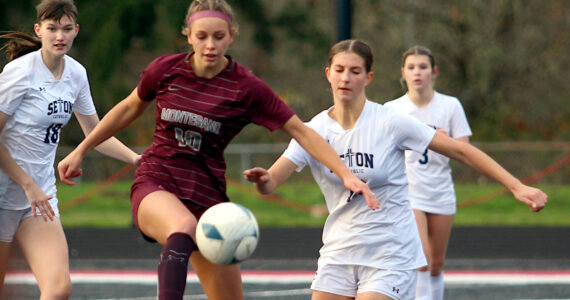 RYAN SPARKS | THE DAILY WORLD Montesano’s Lex Stanfield (10) competes for possession against Seton Catholic’s Addie Sahler during the Bulldogs’ 3-2 loss (5-4 on penalty kicks) in the 1A District 4 Championship on Saturday in Tenino.