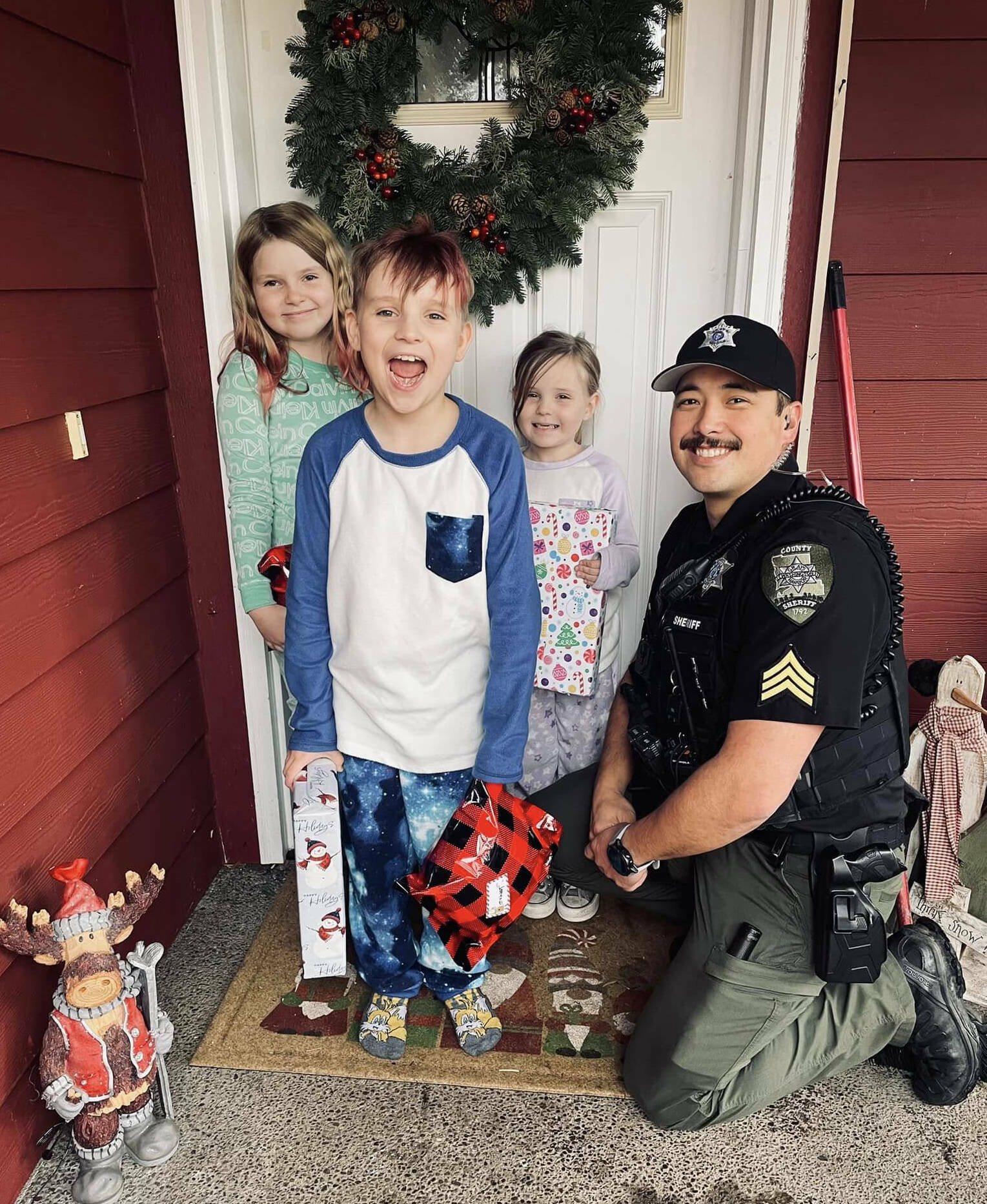 The Daily World file photo
Sgt. Stephen Heller helps distribute toys during last years Grays Harbor County Sheriffs Department Holiday Toy Drive.