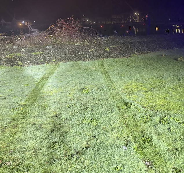 Tire tracks lead toward the Hoquiam River.