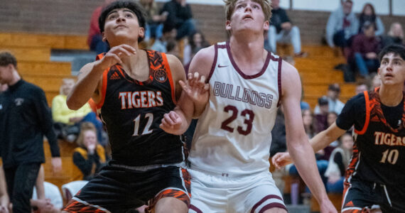 PHOTO BY FOREST WORGUM Montesano’s Caden Grubb (23) competes for a rebound against Centralia’s Alfonso Villalba during the Bulldogs’ 69-57 victory on Monday in Montesano.