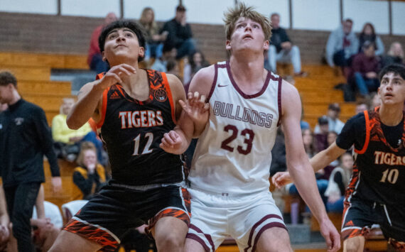 PHOTO BY FOREST WORGUM Montesano’s Caden Grubb (23) competes for a rebound against Centralia’s Alfonso Villalba during the Bulldogs’ 69-57 victory on Monday in Montesano.