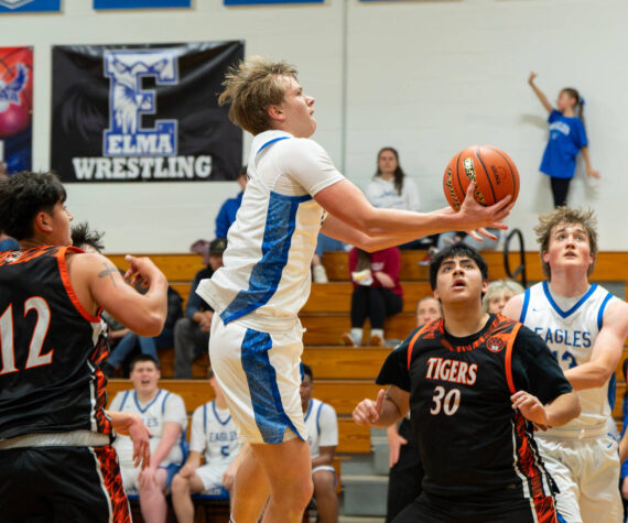 NICOLE SHANNON | MAIN FOCUS MEDIA Elma senior Isaac McGaffey scores on a drive to the basket during the a 66-56 win over Centralia on Tuesday at Elma High School.