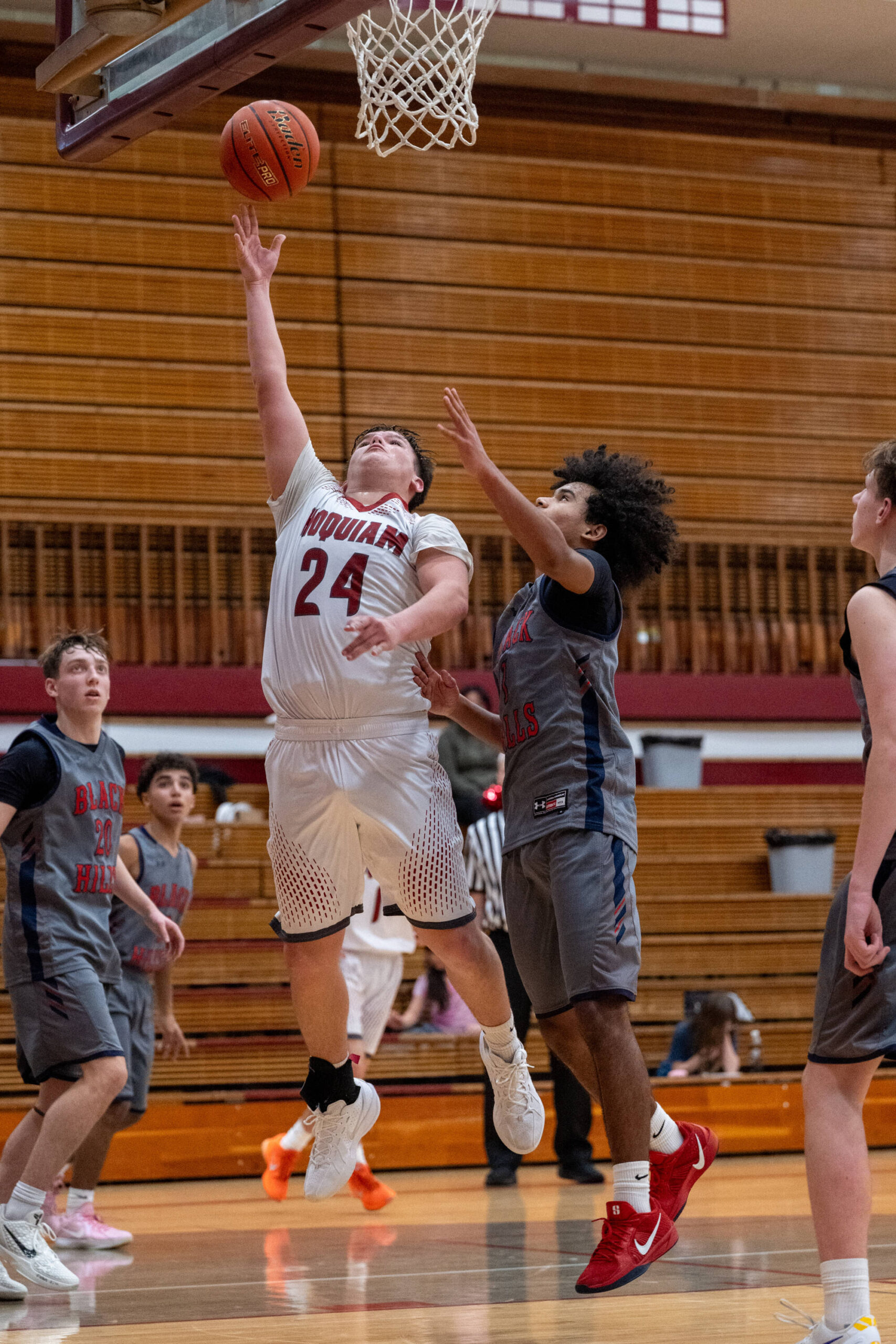 PHOTO BY FOREST WORGUM Hoquiam guard Lincoln Niemi (24) scores on a layup during a 56-48 loss to Black Hills on Friday at Hoquiam High School.