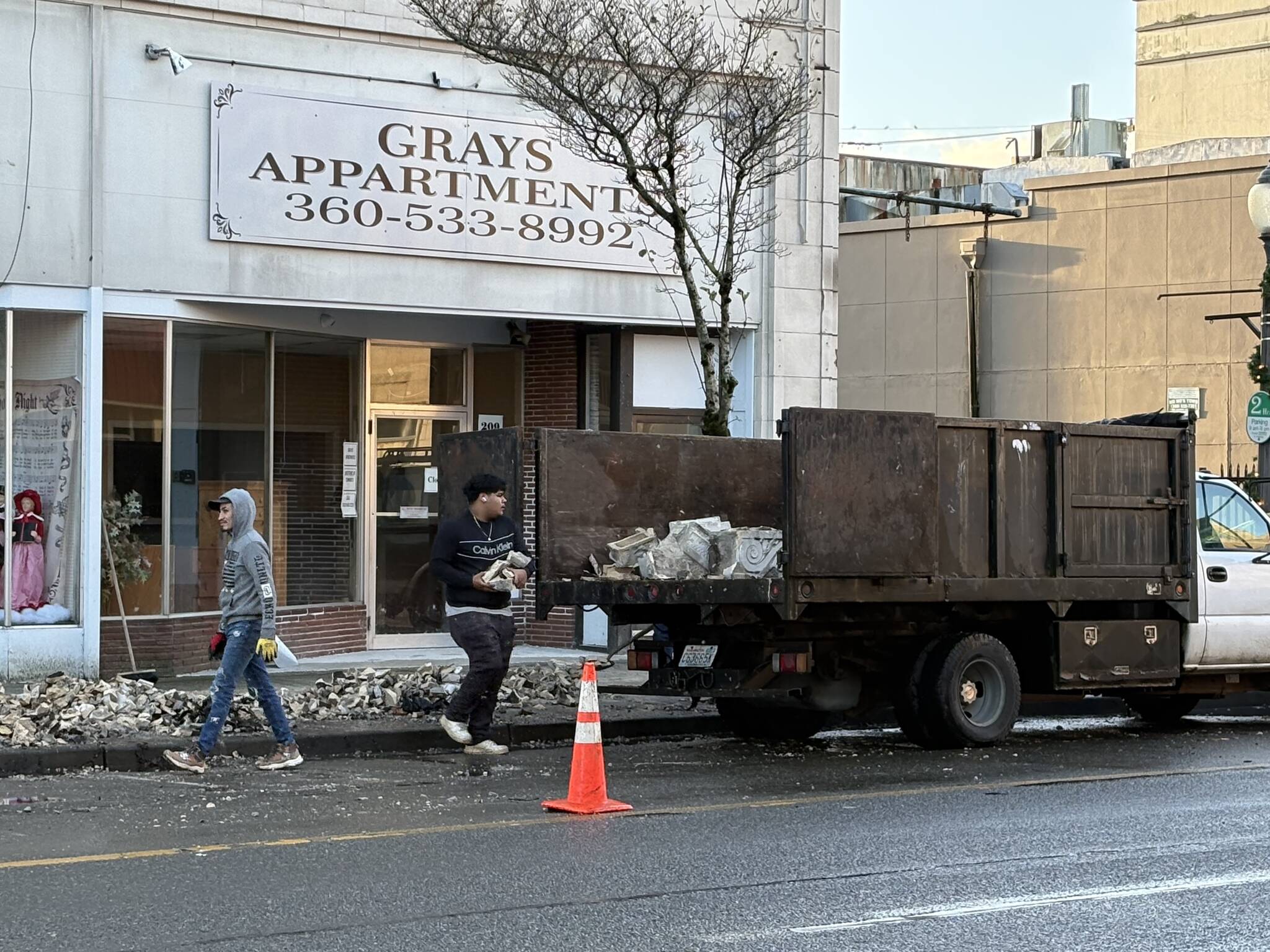 Jerry Knaak / The Daily World
Workers clear debris from the fallen facade of the Grays Apartment building on the 200 block of E Wishkah in Aberdeen.