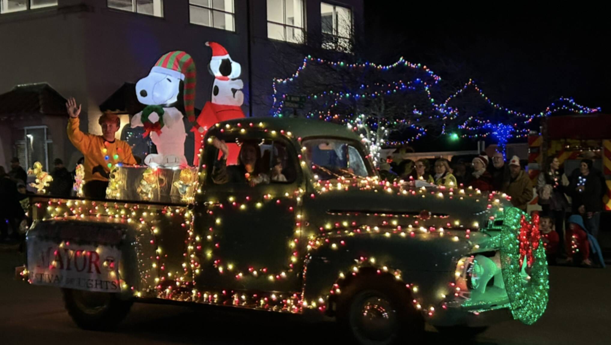 Montesano Mayor Tyler Trimble waves from the back of his vintage pickup truck float at the grand parade.