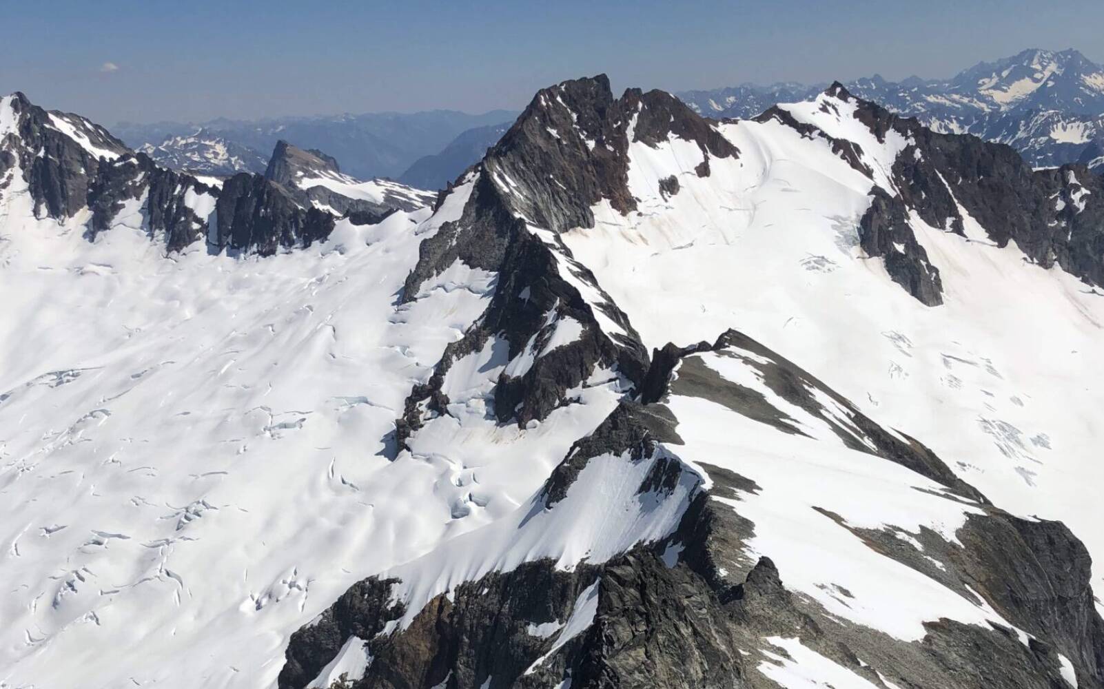 Bill Lucian / Washington State Standard
The Boston Glacier, left, viewed from Forbidden Peak, falls away from Boston Peak in the North Cascades. Boston Basin to the right.