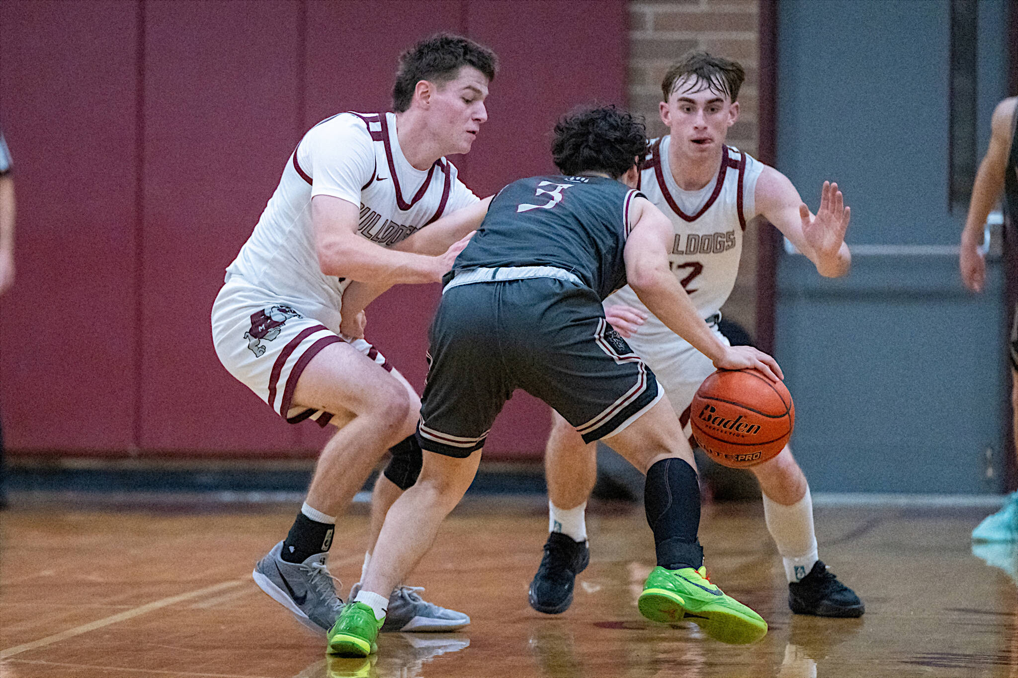 PHOTO BY FOREST WORGUM Montesanos Colton Grubb (left) and Ryan Weidman defend W.F. Wests Alex Stafford during a 54-48 overtime victory on Thursday in Montesano.