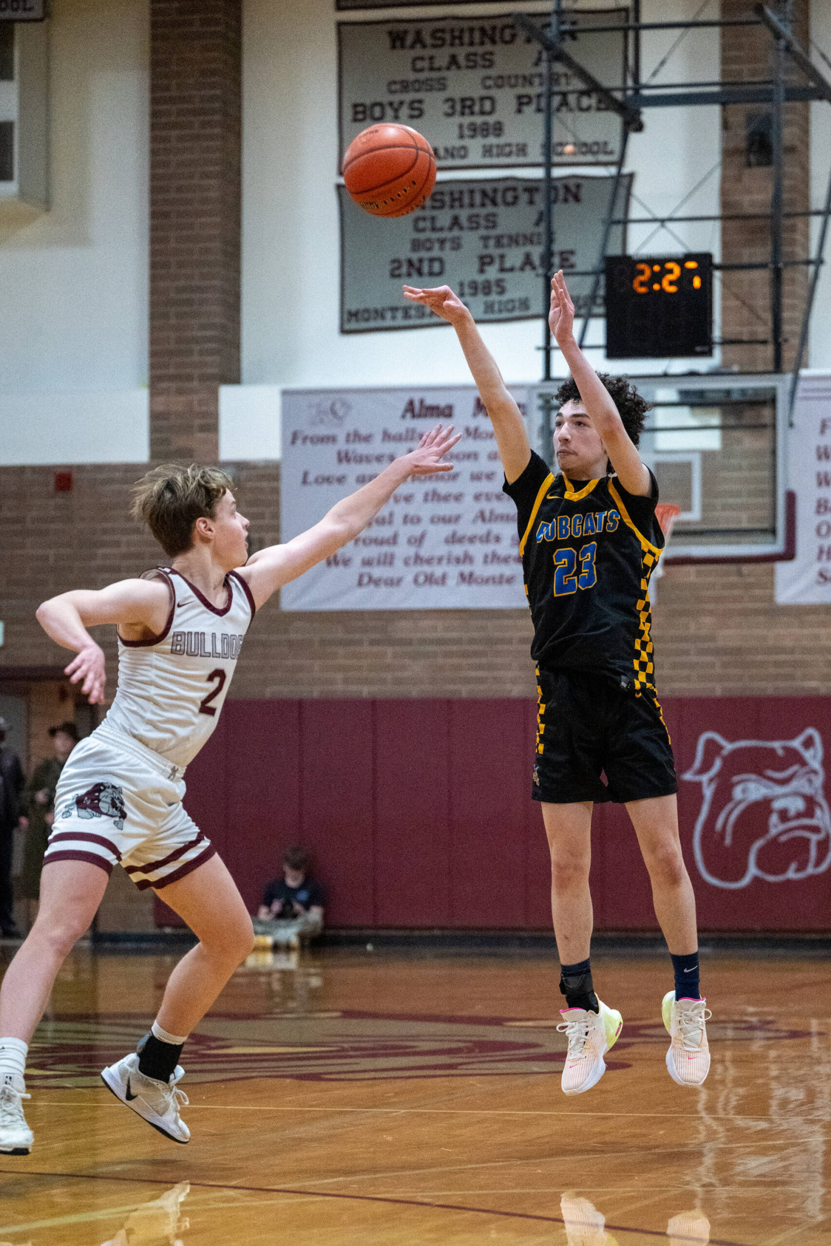 PHOTO BY FOREST WORGUM Aberdeen guard Jhacob Quezada (right) hits a 3-pointer while defended by Montesanos Andrew Bruland during the Bobcats 63-53 victory on Monday at Montesano High School.