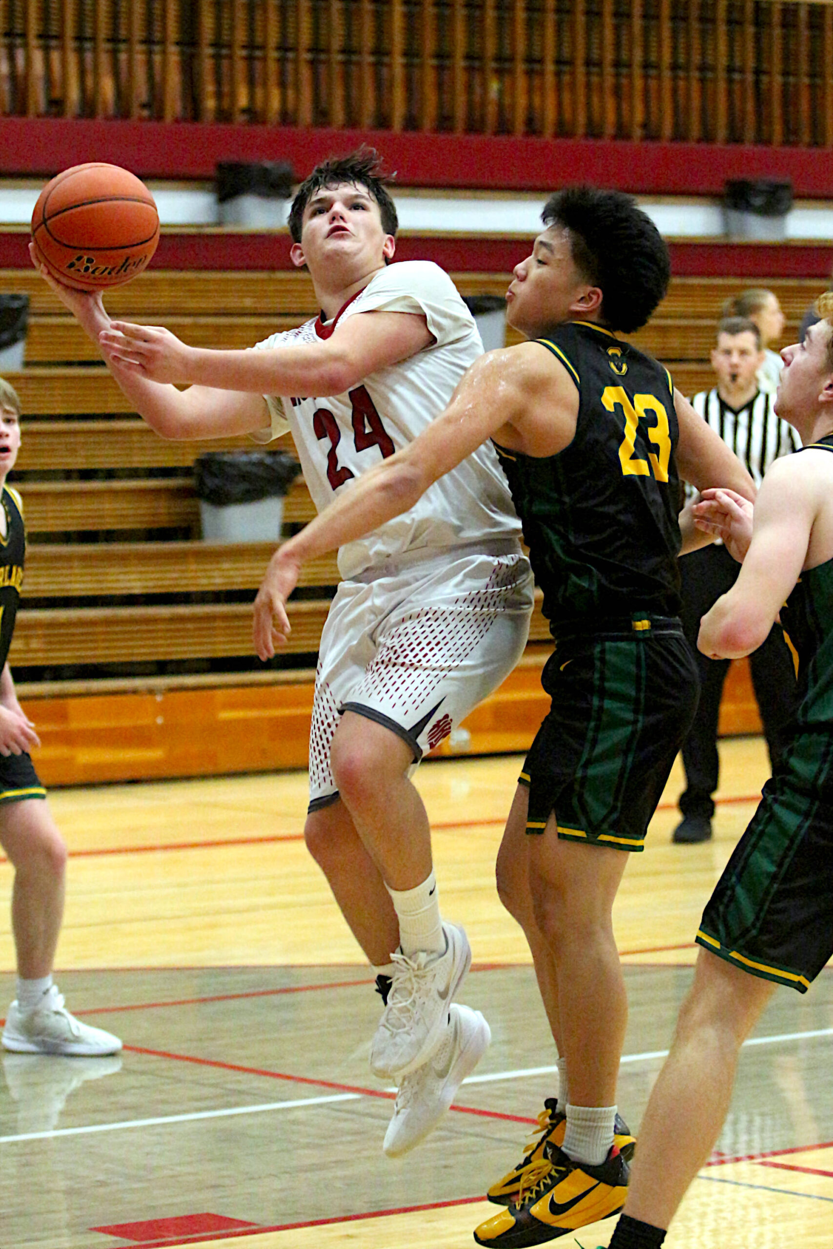 RYAN SPARKS | THE DAILY WORLD Hoquiams Lincoln Niemi (24) scores and is fouled by Overlakes Derek Li during the Grizzlies 55-54 win on Tuesday at Hoquiam High School.
