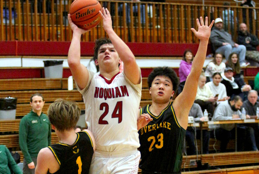 <p>RYAN SPARKS | THE DAILY WORLD Hoquiam&rsquo;s Lincoln Niemi (24) shoots while defended by Overlake&rsquo;s Carter Douvia (1) and Derek Li during the Grizzlies&rsquo; 55-54 victory on Tuesday at Hoquiam Square Garden.</p>