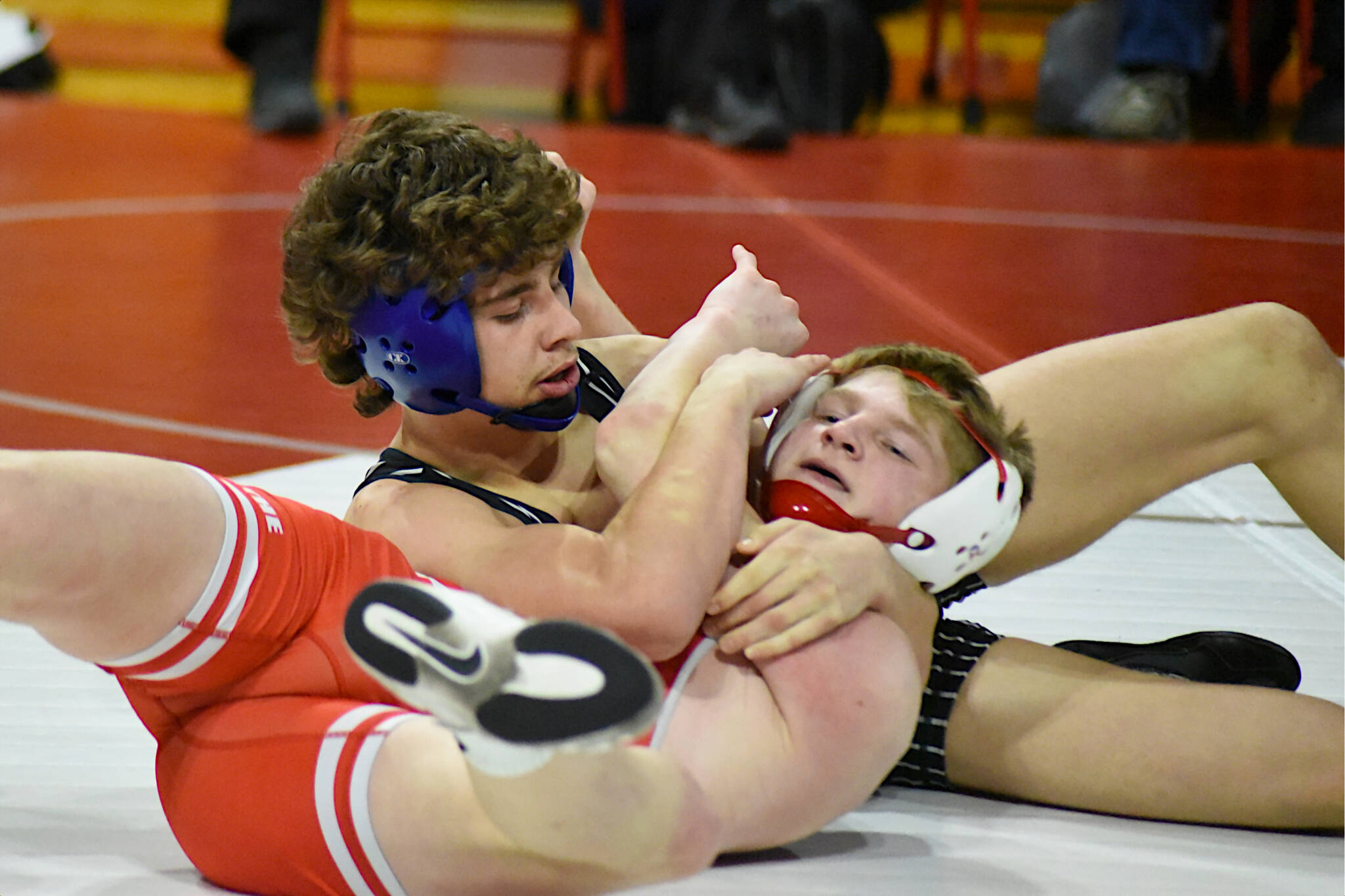 PHOTO BY SUE MICHALAK BUDSBERG Elmas Aidyn Johnson (top) wrestles Castle Rocks Boston Carter during the 126-pound title match of the Jim Bair Invitational on Saturday at Castle Rock High School.