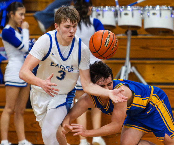 <p>PHOTO BY MIKE ROBERTS Elma&rsquo;s Isaac McGaffey (3) grabs a loose ball during a 68-37 victory over Rochester on Friday at Elma High School.</p>