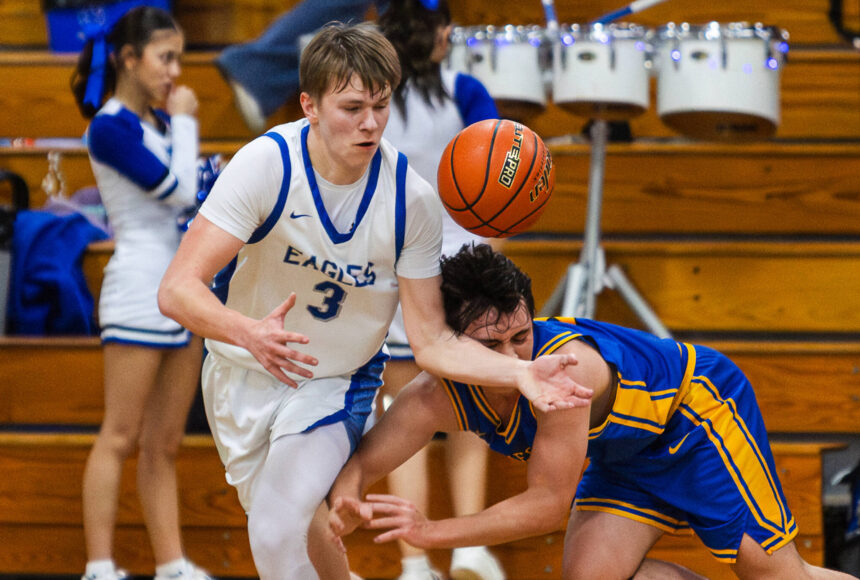 <p>PHOTO BY MIKE ROBERTS Elma&rsquo;s Isaac McGaffey (3) grabs a loose ball during a 68-37 victory over Rochester on Friday at Elma High School.</p>
