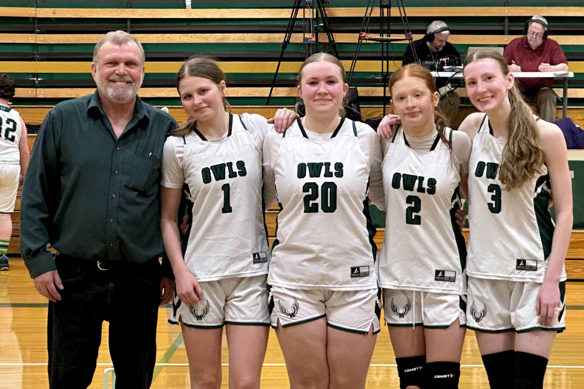 PHOTO COURTESY OF KRISTIN MASTELLER Mary M. Knight seniors (from left) Cloey Fletcher, Maelynn Nygaard, Carissa Reeves and Andiana Ziegler pose for a photo with head coach Jake Goldy ahead of a 46-39 Senior Night victory over Oakville on Wednesday in Matlock.