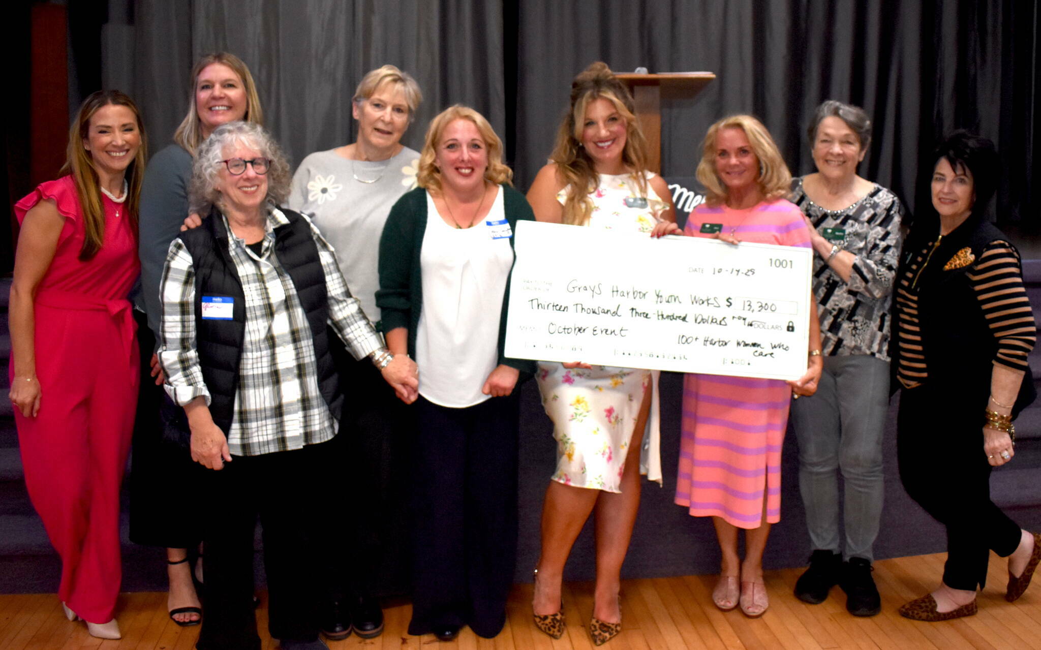 Jerry Knaak / The Daily World
Jessica Eddington of Grays Harbor Youth Works accepts a ceremonial $13,300 check from 100+ Harbor Women Who Care at the October giving event at the Hoquiam Elks Lodge. The actual amount of the donation was $14,000.