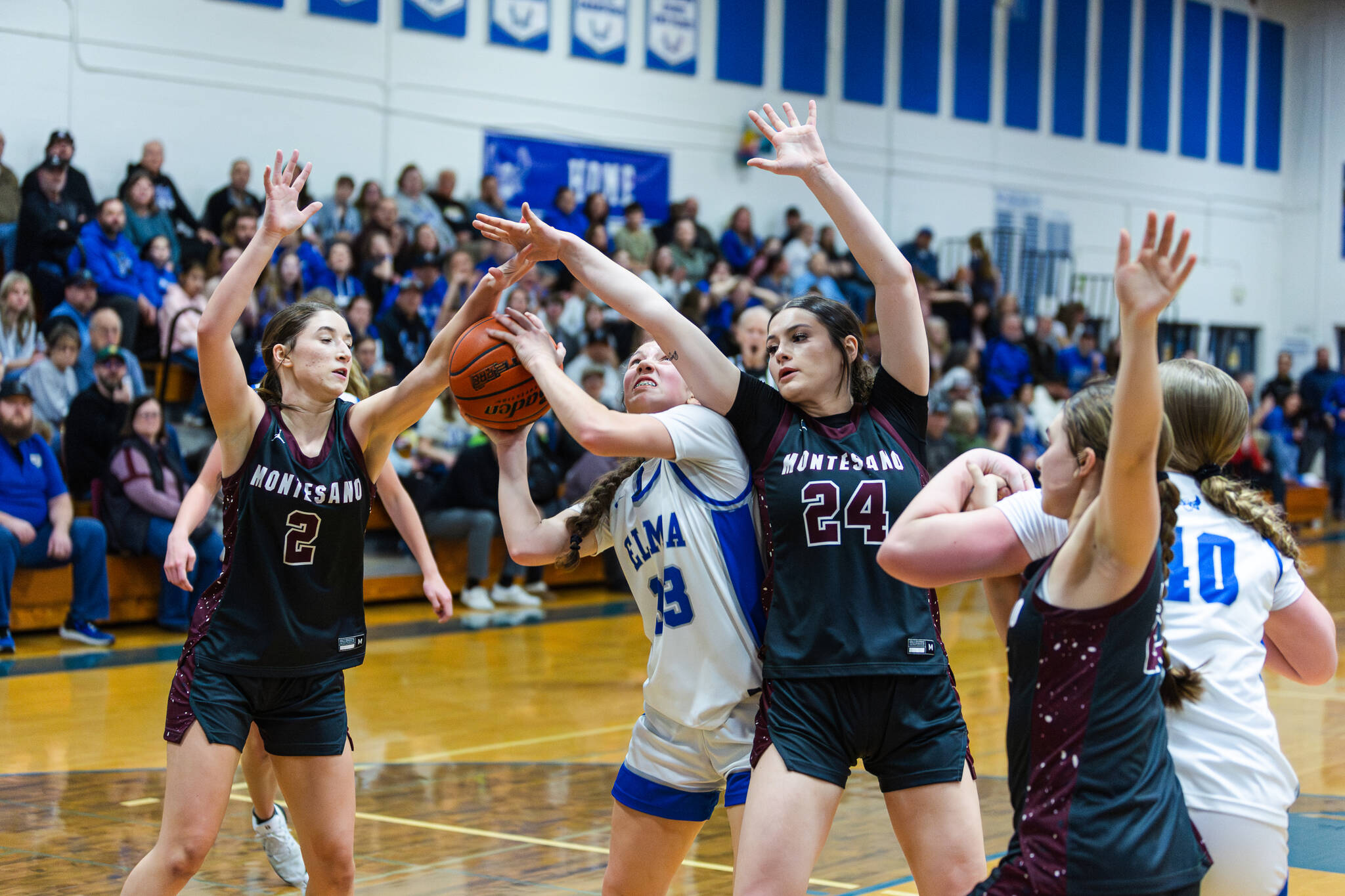 PHOTO BY MIKE ROBERTS Montesanos Jordy Perry (2) and Jillie Dalan (24) defend against Elmas Olivia Moore during the Bulldogs 42-41 victory on Thursday at Elma High School.