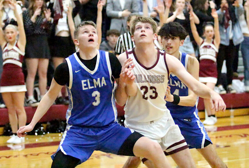 <p>RYAN SPARKS | THE DAILY WORLD Elma&rsquo;s Isaac McGaffey (3) and Montesano&rsquo;s Caden Grubb (23) compete for a rebound during the Bulldogs&rsquo; 54-32 victory on Friday at Montesano High School. With the win, Montesano earned the No. 1 playoff seed in the 1A Evergreen League.</p>