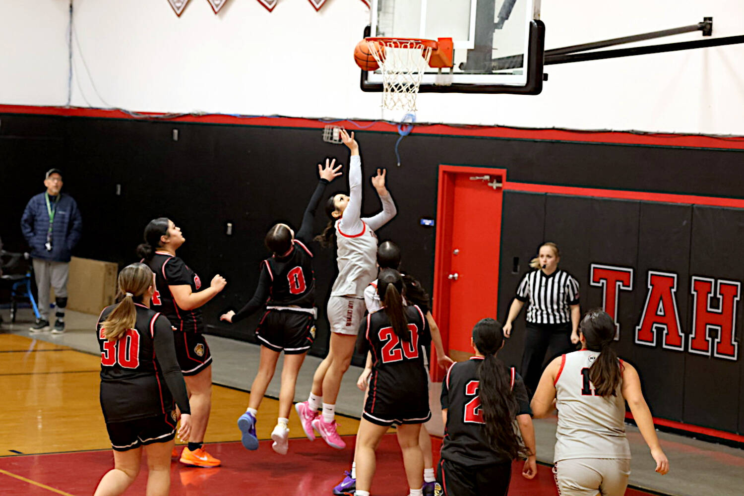 PHOTO BY TIA CHENEY Taholahs Noelani McCrory (middle) scores two of her 14 points in a 71-25 win over Oakville in a 1B District 4 Tournament game on Tuesday in Taholah.