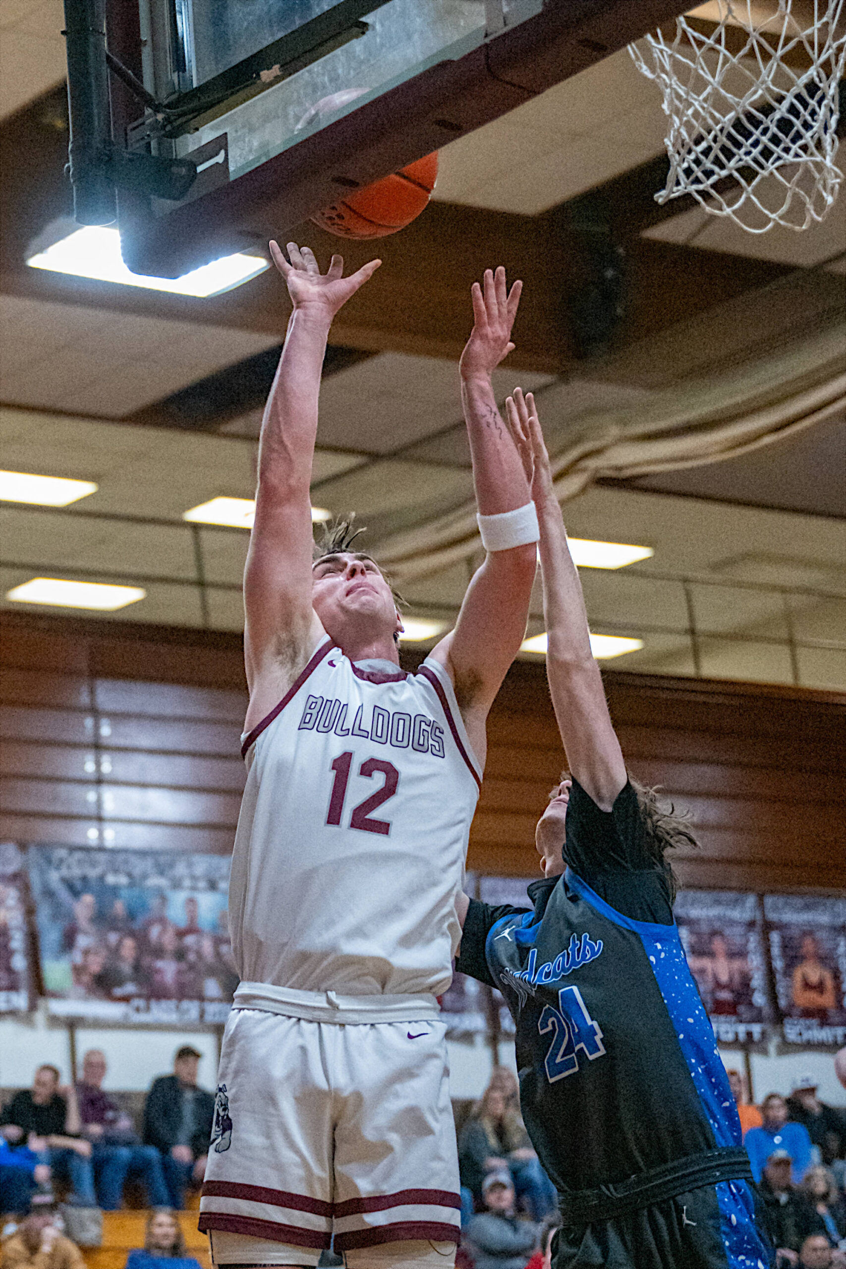PHOTO BY FOREST WORGUM Montesanos Ryan Weidman (12) shoots against La Centers Kaden Kohn during the Bulldogs 75-56 win in a 1A District 4 Tournament game on Thursday in Montesano. Weidman had a game-high 25 points in the win.