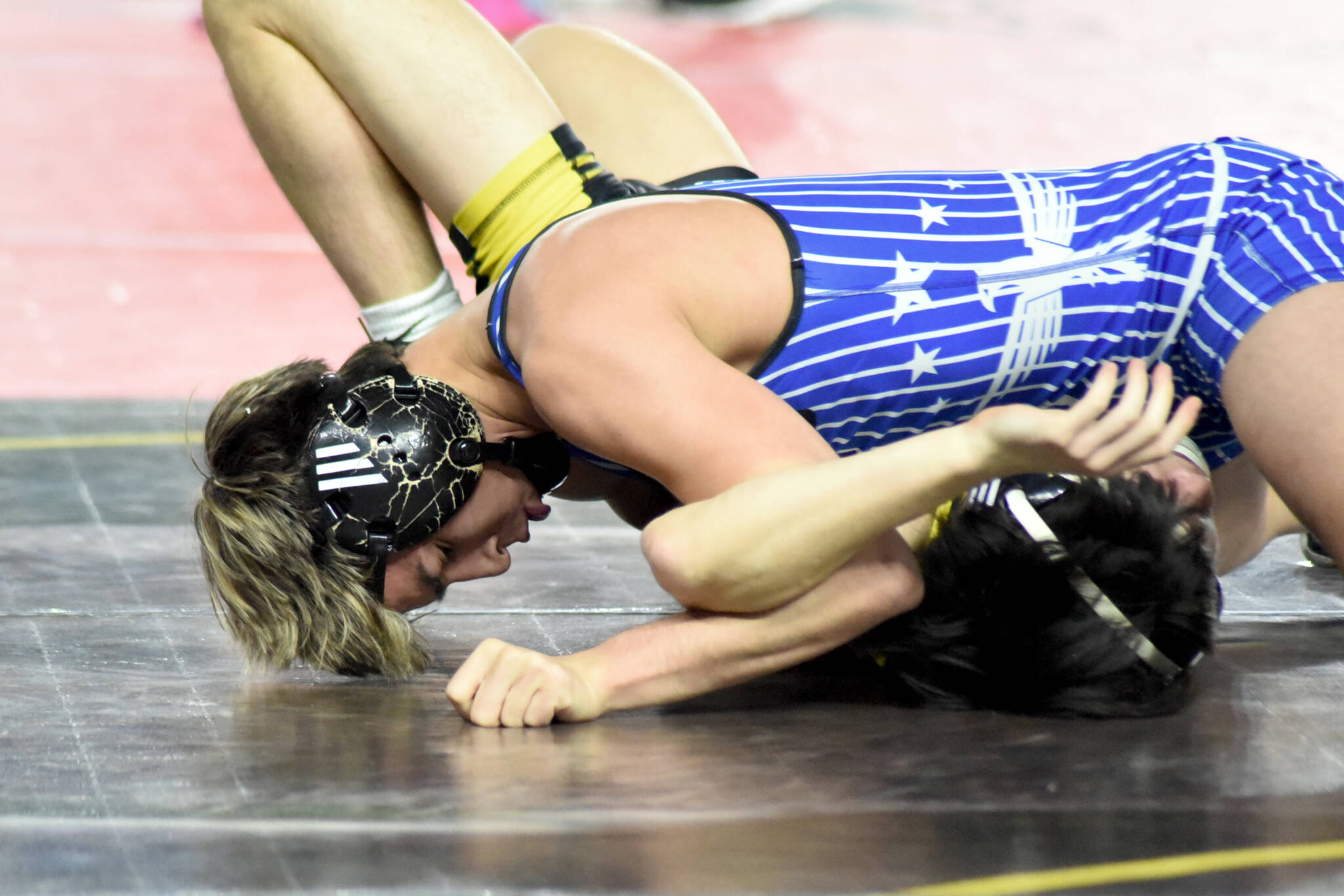 PHOTO BY SUE MICHALAK BUDSBERG Elmas Xavier Espinoza (top) works to pin Vashon Islands Taevin Gilbert during a 132-pound match at the Mat Classic XXXVII on Friday at the Tacoma Dome. Espinoza won his second-consecutive state championship on Saturday.