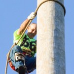 (Corey Morris | Grays Harbor Newspaper Group) Richard Glaves of Cle Elum works his way back down the pole after the local climb event at Loggers Playday on Sunday in Hoquian.