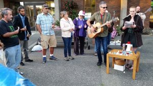 Terri Harber/Daily World Wil Russoul and Nita Cross, who also goes by the name Wednesday, perform outside of Aberdeen City Hall on Wednesday night. About 40 people held a candle light vigil to remember Brooke Sandback and remind the community about the plight of the local homeless population.