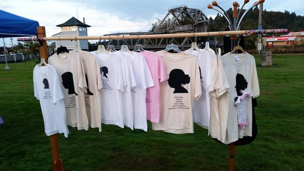 (Terri Harber/The Daily World) T-shirts hang with identities of domestic violence victims hang in Aberdeen&rsquo;s Zelasco Park on Wednesday. It was the site of the 4th Annual Domestic Violence Candle Light Vigil.